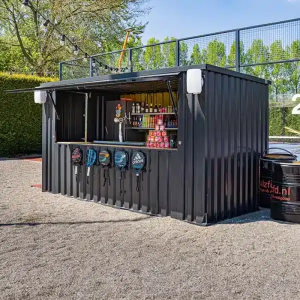 Mobiele baropstelling met uitgiftevenster, ingericht als drank- en snackpunt bij een sportaccommodatie